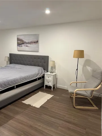 a bedroom with a bed and a desk