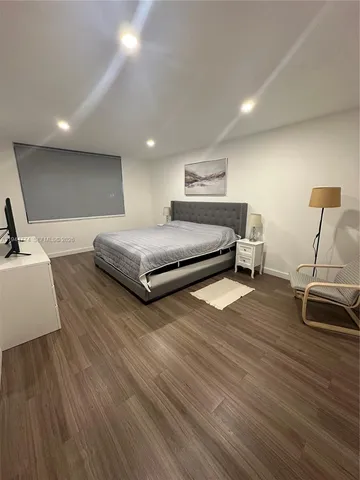 a bedroom with a bed and a night stand