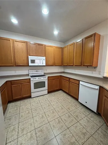 a kitchen with a sink a stove top oven and cabinets