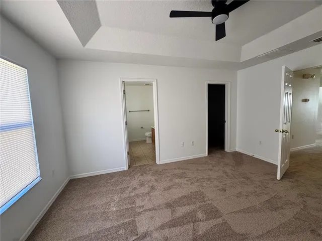 a view of empty room with ceiling fan