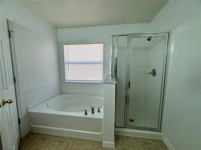 a bathroom with a bathtub and shower