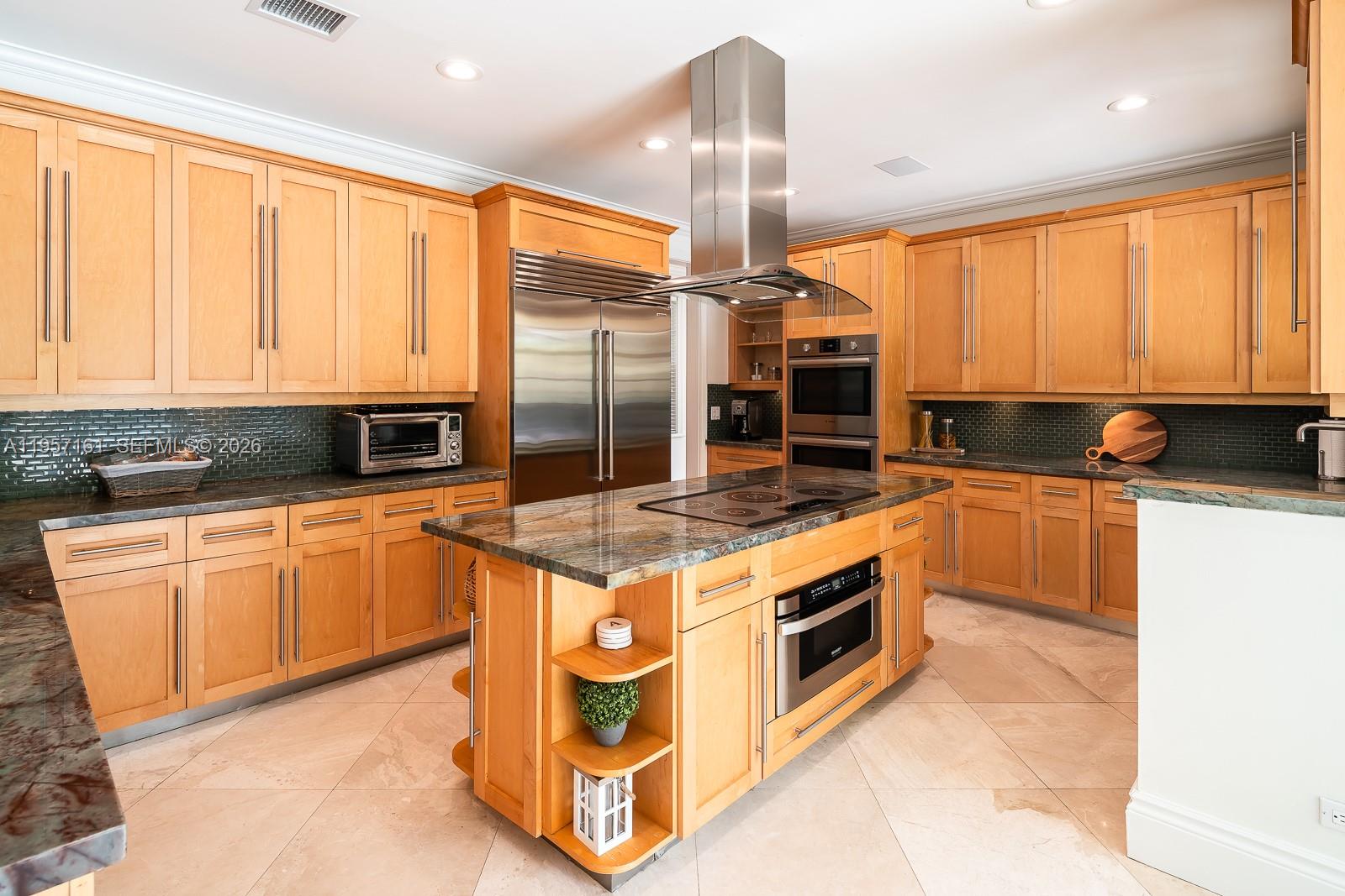 5770 Southwest 128th Street Pinecrest, FL 33156 - Photo 17 of 37 a kitchen with stainless steel appliances granite countertop a stove a sink and a microwave