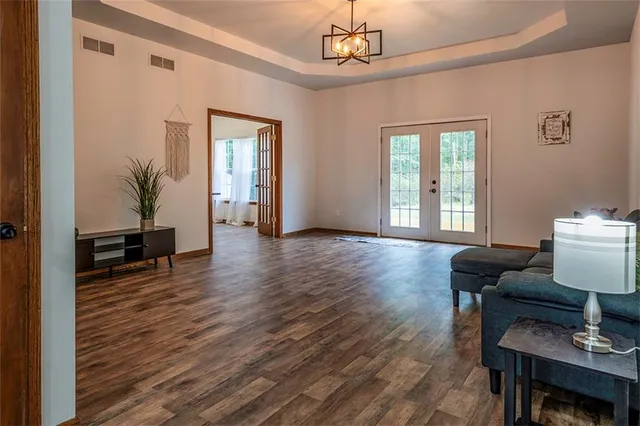 a living room with furniture and wooden floor