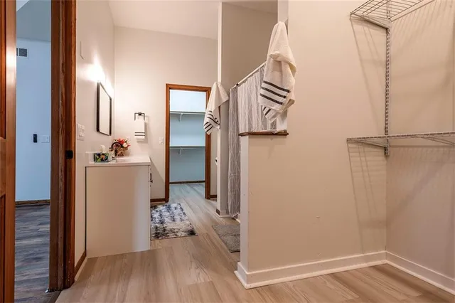 a view of hallway with wooden floor