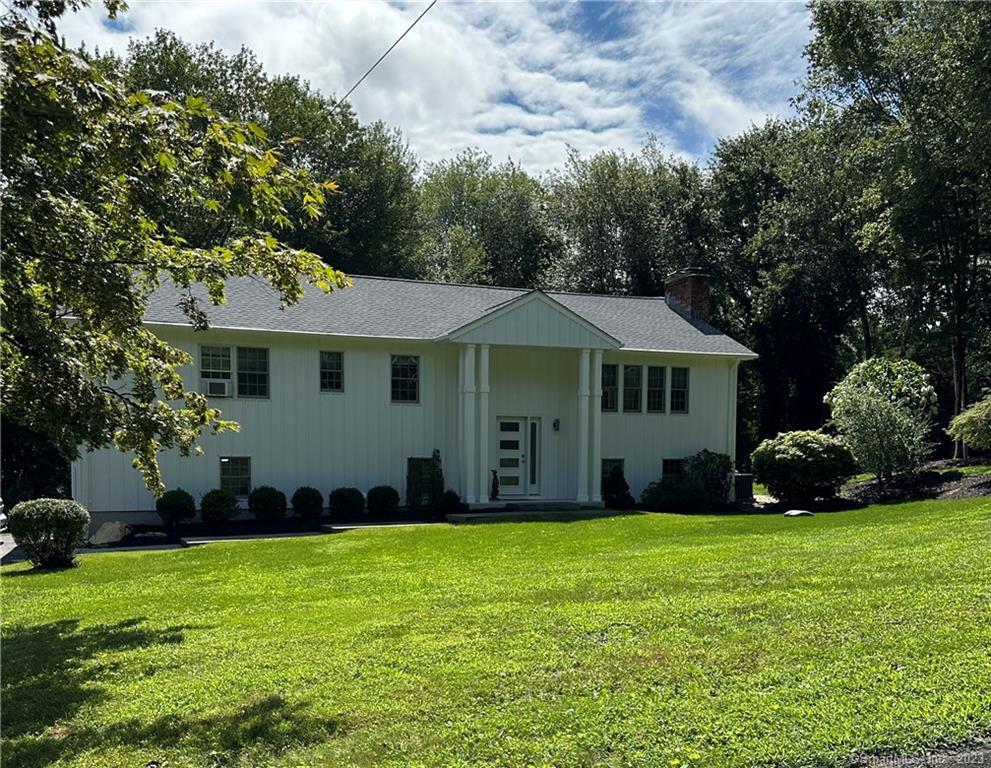 a front view of a house with a garden