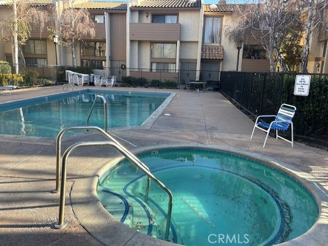 a swimming pool with outdoor seating and yard