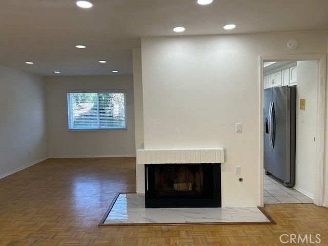 a view of a livingroom with a fireplace and window