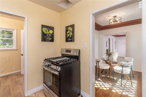 a kitchen with stainless steel appliances a stove a table and a refrigerator