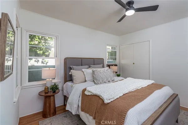 a bedroom with a bed potted plant with the window