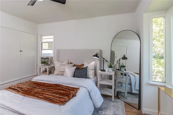 a bedroom with bed and wooden floor