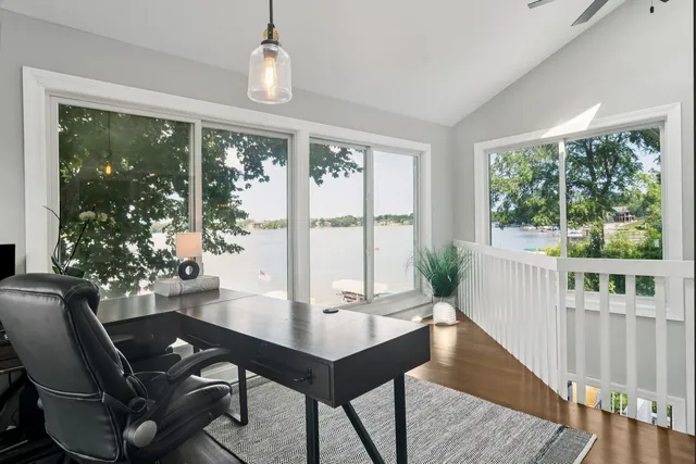a view of a workspace with furniture and a window