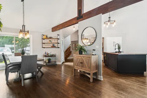 a living room with furniture a air conditioner and a large window