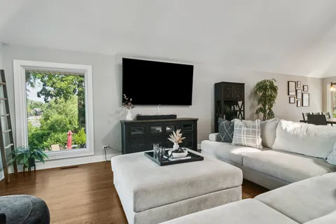 a living room with fireplace furniture and a flat screen tv