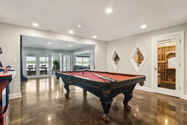 a room with furniture pool table and flat screen tv