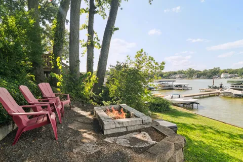 a view of swimming pool with outdoor seating and lake