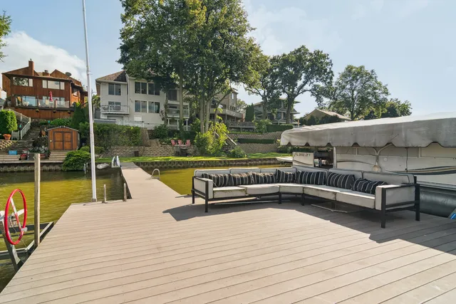 a view of a roof deck with couches and wooden floor