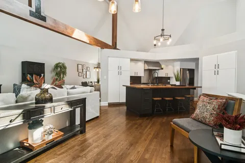 a living room with stainless steel appliances kitchen island granite countertop furniture and a kitchen view