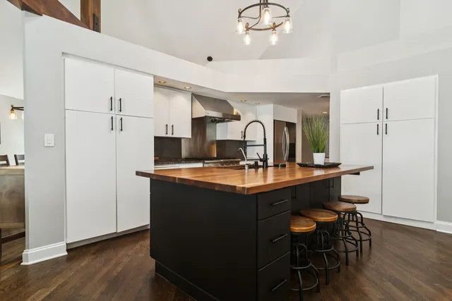 a kitchen with stainless steel appliances granite countertop a sink and a refrigerator