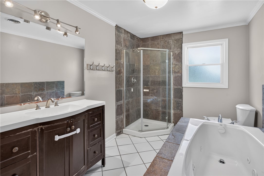 118 Bryson Road Anderson, SC 29625 - Photo 17 of 36 Stone tile detailing and a deep soaking tub highlight this updated bathroom space.