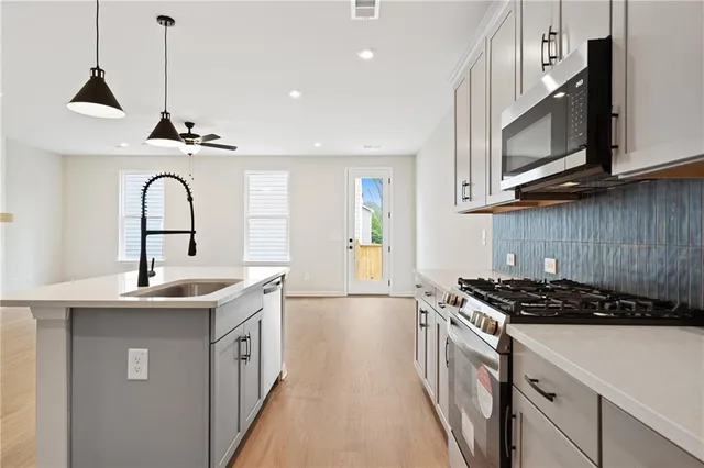 a kitchen with a sink and stove