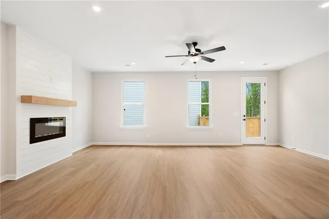 a view of kitchen with granite countertop stainless steel appliances cabinets a sink and a window