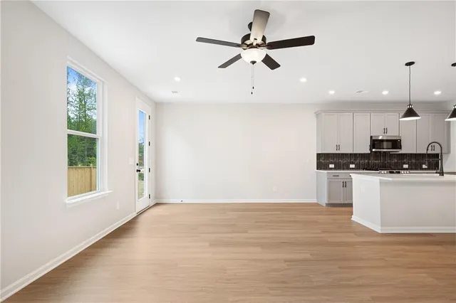 a view of a kitchen with a sink wooden floor and a chandelier