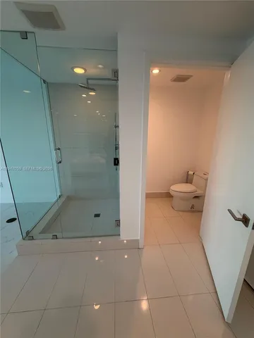 a bathroom with a shower and a toilet