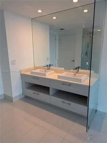 a room with a bed and a mirror