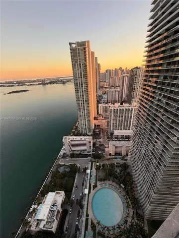 a view of a balcony with two chairs and a stove