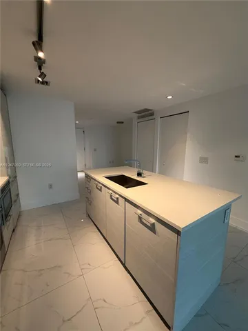 a kitchen with a cabinets and white appliances