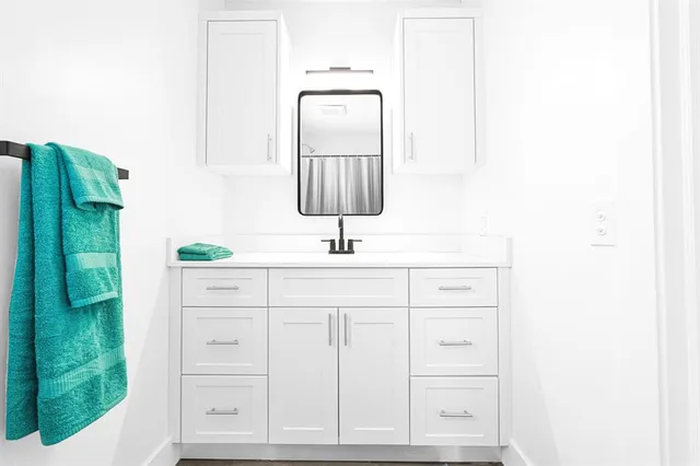 a view of a sink and a flat screen tv