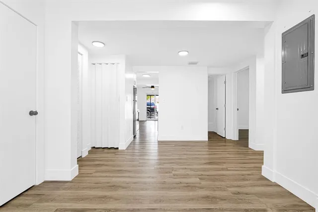 a view of a kitchen with a sink and refrigerator