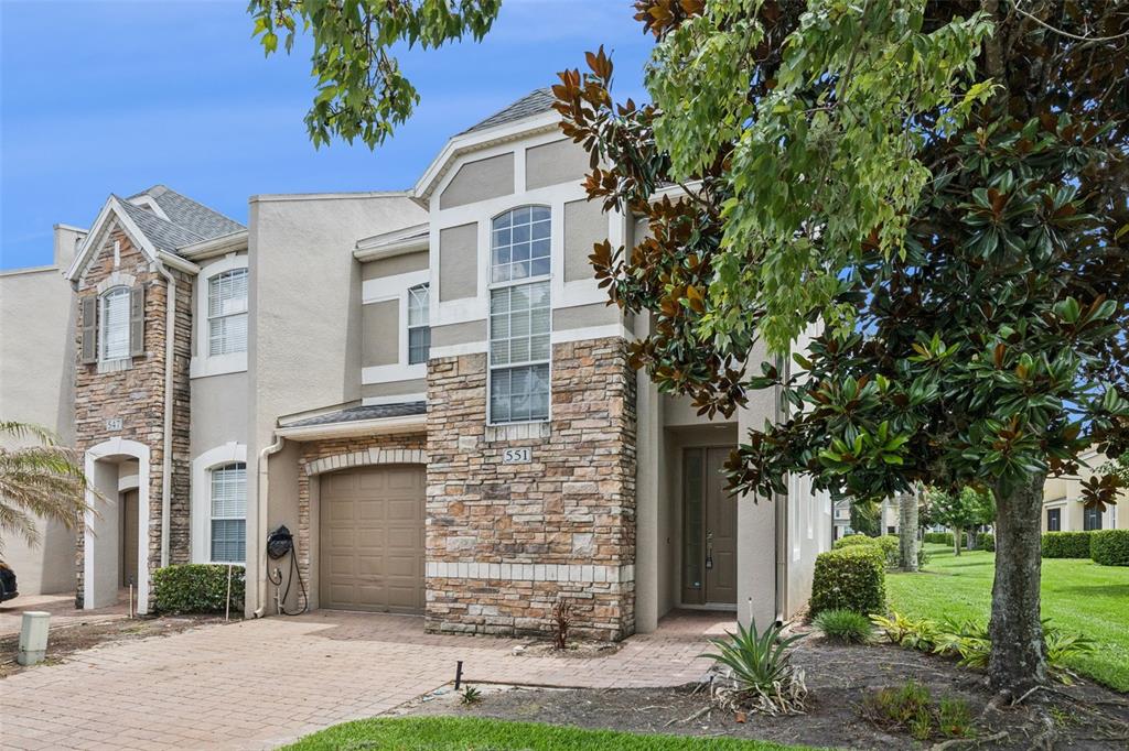 551 Terrace Spring Drive Orlando, FL 32828 - Photo 2 of 41 a front view of a house with a garden