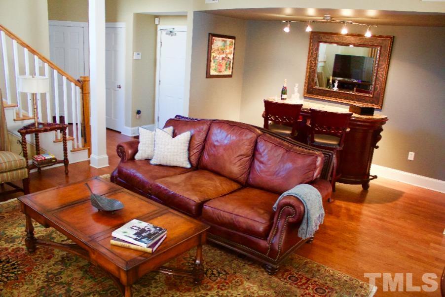 613 West Cabarrus Street, Unit 202 Raleigh, NC 27603 - Photo 2 of 17 a living room with furniture and wooden floor