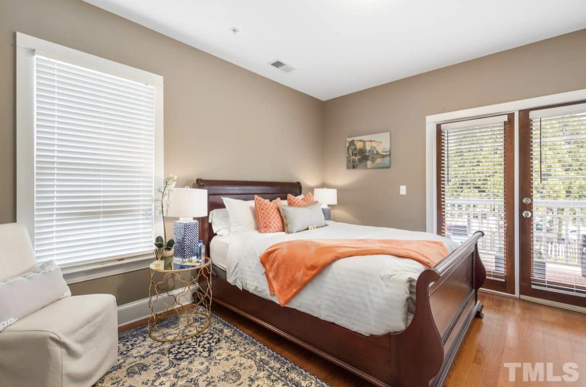 613 West Cabarrus Street, Unit 202 Raleigh, NC 27603 - Photo 12 of 17 a bedroom with bed and a window