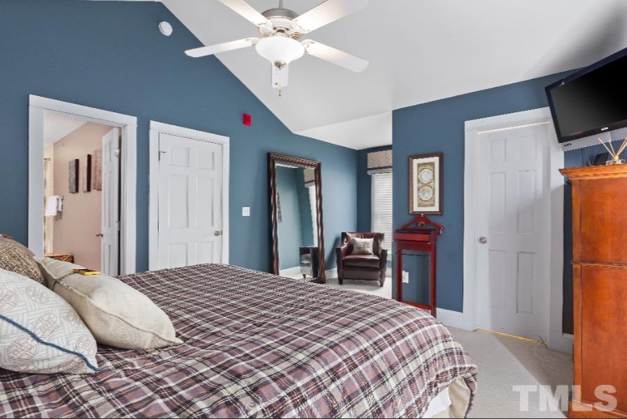 613 West Cabarrus Street, Unit 202 Raleigh, NC 27603 - Photo 3 of 17 a bedroom with a bed and a flat screen tv