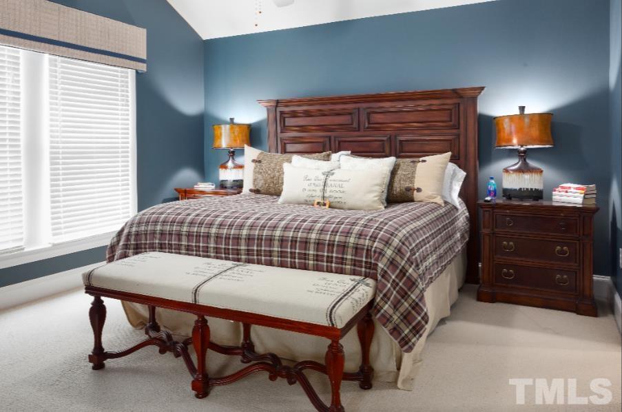 613 West Cabarrus Street, Unit 202 Raleigh, NC 27603 - Photo 4 of 17 a bedroom with a bed and a dresser in it