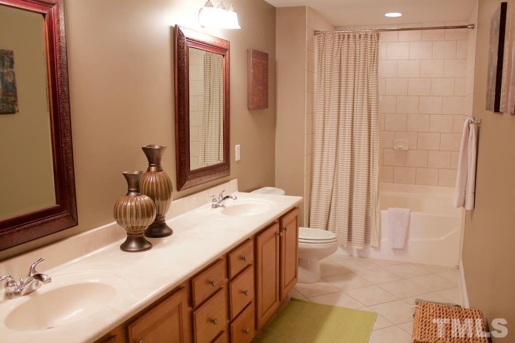 613 West Cabarrus Street, Unit 202 Raleigh, NC 27603 - Photo 5 of 17 a bathroom with a double vanity sink and a mirror