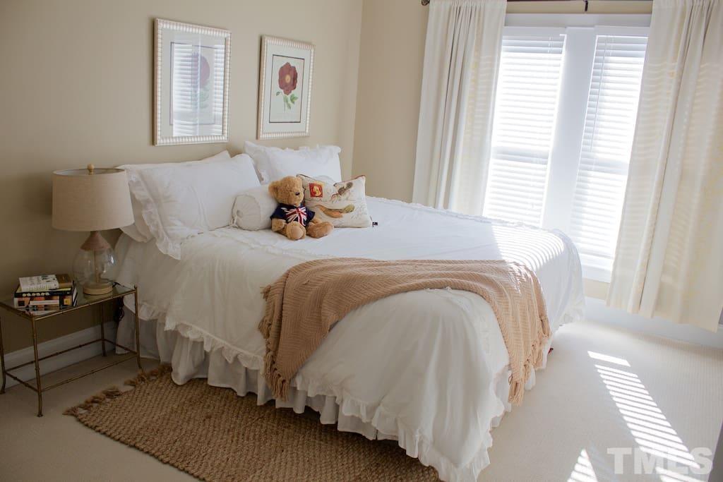 613 West Cabarrus Street, Unit 202 Raleigh, NC 27603 - Photo 7 of 17 a bedroom with a bed and a window