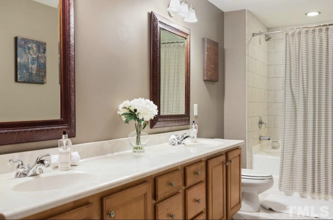 613 West Cabarrus Street, Unit 202 Raleigh, NC 27603 - Photo 9 of 17 a bathroom with a sink a toilet and shower