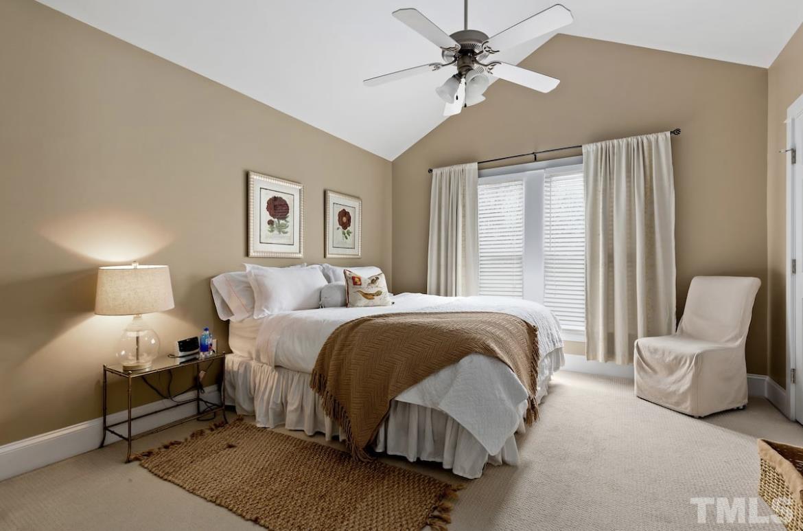 613 West Cabarrus Street, Unit 202 Raleigh, NC 27603 - Photo 10 of 17 a bedroom with a bed chairs and window