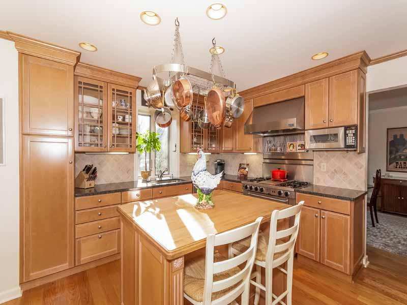 12 Ridge Farms Road Norwalk, CT 06850 - Photo 4 of 23 a kitchen with a refrigerator a stove a sink dishwasher a dining table and chairs with wooden floor