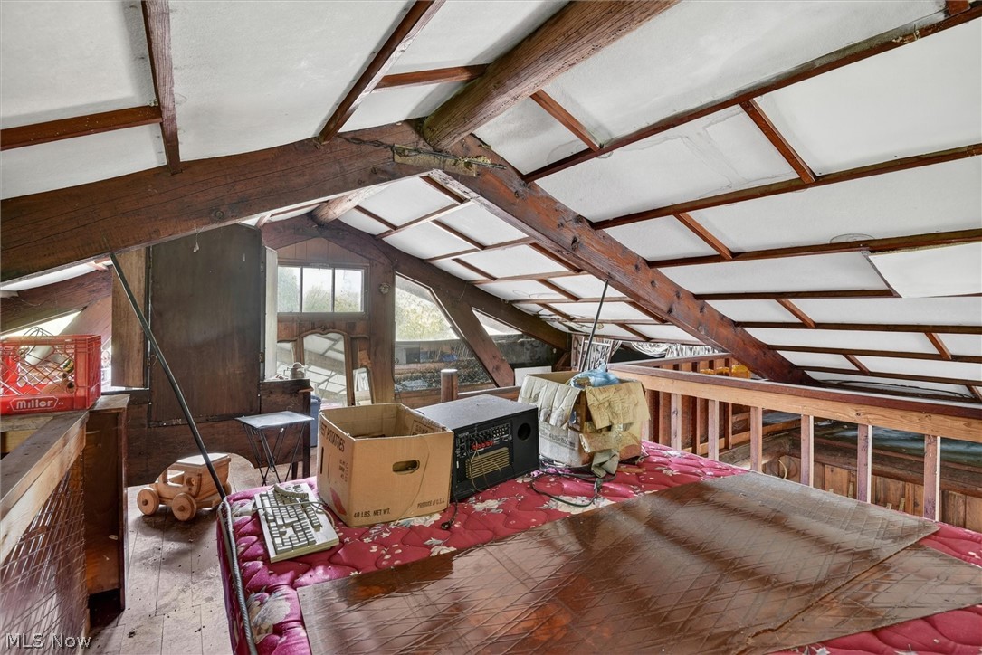 1526 Stevenson Road Ashtabula, OH 44004 - Photo 39 of 50 Attic space featuring exposed wood beams, sloped ceilings, and multiple windows