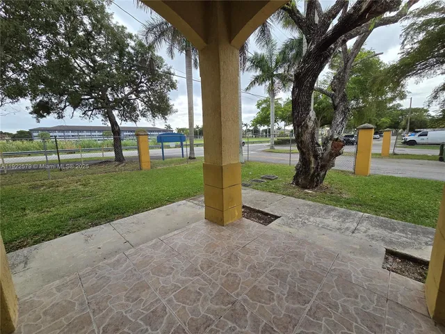 a view of a park with large trees