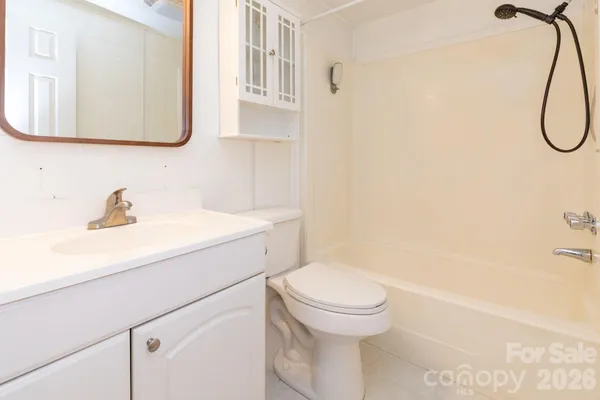 a bathroom with a sink a toilet and a shower