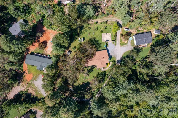 an aerial view of a house with a yard and garden