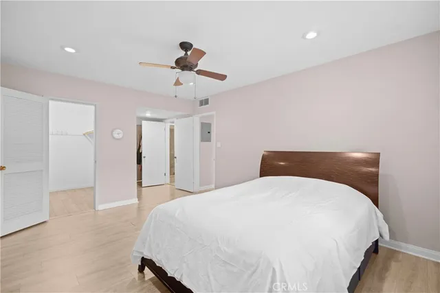 a spacious bedroom with a bed and a chandelier