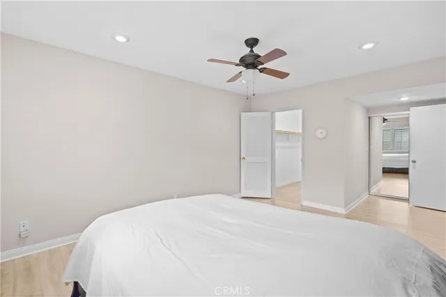 a bedroom with a large bed and a chandelier