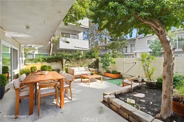 a view of a patio with table and chairs and a barbeque
