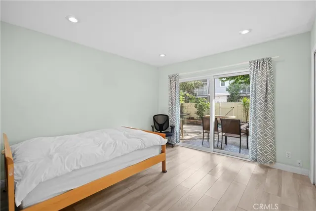 a bedroom with a bed and large window